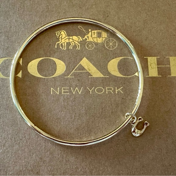 Coach Gold-tone Skinny Bangle Bracelet with Dainty Signature C Dangling Charm. - Picture 1 of 6